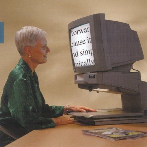 A woman using a video magnifier to read.